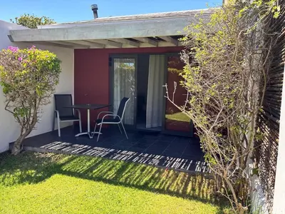 a patio with a table and chairs in a yard at 2stay Apartment Calla - Cape Town Bloubergstrand in Cape Town