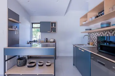 a kitchen with blue cabinets and a counter at 2stay Apartment Calla - Cape Town Bloubergstrand in Cape Town