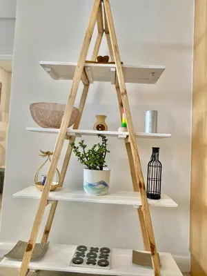 a ladder shelf in a living room with shelves at Wake Up to the Waves - Portico in Cape Town