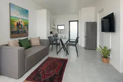 a living room with a couch and a table at Perlemoen Apartments in Hermanus