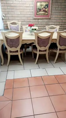 a wooden table and chairs on a patio at Hussein accommodation in Cape Town