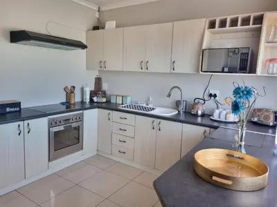 a kitchen with a wooden bowl on a counter at Grace Space in Plattekloof in Cape Town