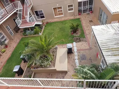 an aerial view of a yard with palm trees at Azzure Apartments 3 sleeper Strand in Strand