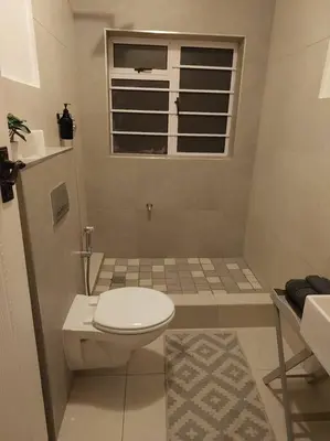 a small bathroom with a toilet and a window at Azzure Apartments 3 sleeper Strand in Strand
