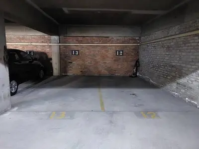 an empty parking garage with a brick wall at Azzure Apartments 3 sleeper Strand in Strand