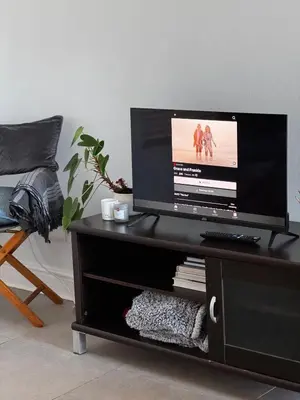 a flat screen tv on a black entertainment center at Serene loft apartment in Cape Town