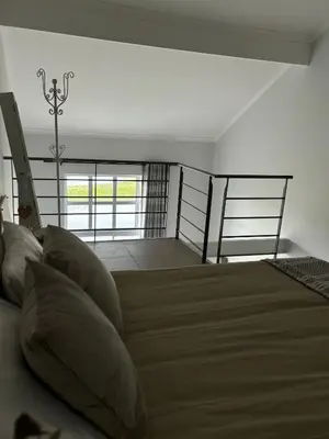 a bedroom with a bed with pillows on it at Serene loft apartment in Cape Town