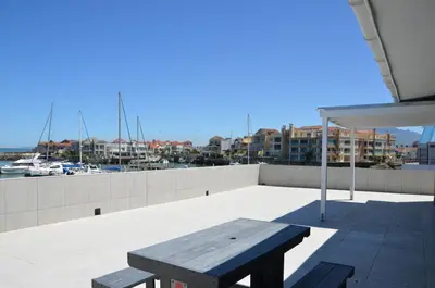 a wooden bench sitting on top of a roof at Harbour View in Cape Town