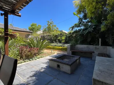 a patio with a bench and a table at 7Pillars Villa Grenache in Durbanville
