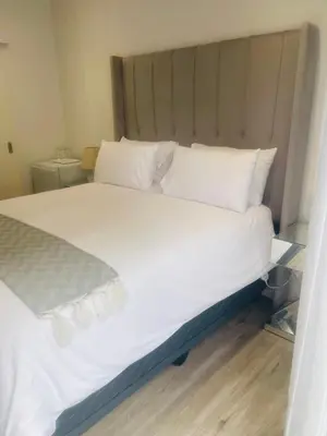 a large bed with white sheets and pillows at Private Luxury Room by 29 Holborn in Cape Town