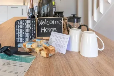 a table with a welcome home sign and some food at 2D on Nansen in Cape Town