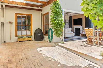 a house with a patio with a table and chairs at 2D on Nansen in Cape Town