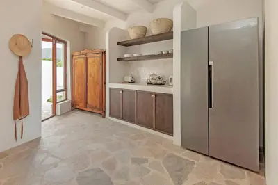 a kitchen with a stainless steel refrigerator at Heartwood Cottage in Hermanus