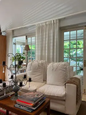 a living room with a white couch and a table at Sandpipers in Hermanus
