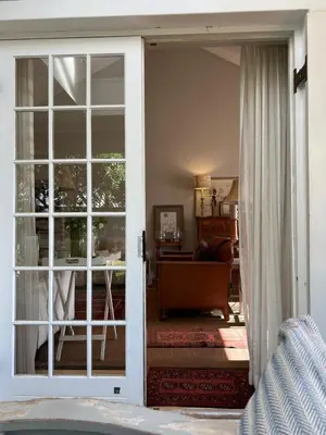 a room with a door open to a living room at Sandpipers in Hermanus