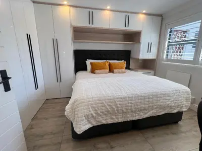 a bedroom with a large bed with two pillows at Luxurious 12 sleeper Appaloosa Villa in Cape Town