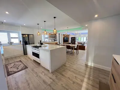 a kitchen and living room with a stove and a table at Luxurious 12 sleeper Appaloosa Villa in Cape Town