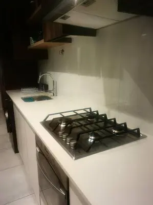 a stove top in a kitchen with a counter at Ocean Palace Table View in Cape Town