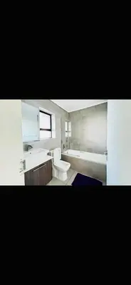 a bathroom with a toilet and a sink and a tub at 6 sleeper apartment near Canal Walk in Cape Town