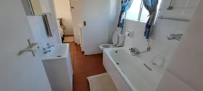 a bathroom with a tub and a sink and a toilet at Unit 75 Hermanus Beach Club in Hermanus