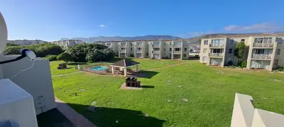 an apartment complex with a large yard with a playground at Unit 75 Hermanus Beach Club in Hermanus