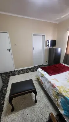 a room with a bed and a table in it at The Vasco in Cape Town