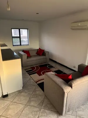 a living room with two couches and a rug at Shalom in Cape Town
