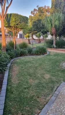 a park with a lawn with trees and bushes at Le Graan Guestroom in Malmesbury