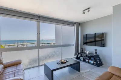 a living room with a view of the ocean at 34 Gordonia, Beachfront Penthouse in Gordonʼs Bay