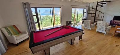 a pool table in the middle of a living room at Paradise 'tween sea and mountain in Pringle Bay