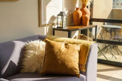 a couch with a pillow on it in a living room at Tyger Lake Luxury Loft in Cape Town