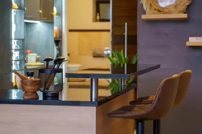 a kitchen counter with two chairs and a counter top at Tyger Lake Luxury Loft in Cape Town