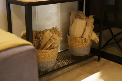 three baskets sitting on a shelf under a table at Tyger Lake Luxury Loft in Cape Town