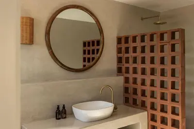 a bathroom with a sink and a mirror at Spioenkop Wines Farm House in Elgin