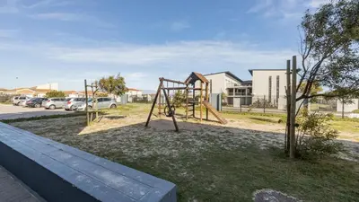 a playground with a swing set in a park at Sunny Escapes Rentals in Cape Town