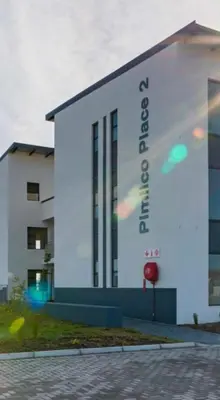 a building with a sign on the side of it at Sunny Escapes Rentals in Cape Town