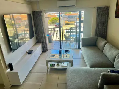 a living room with a couch and a table at Sunny Escapes Rentals in Cape Town