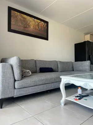 a living room with a couch and a table at Sunny Escapes Rentals in Cape Town