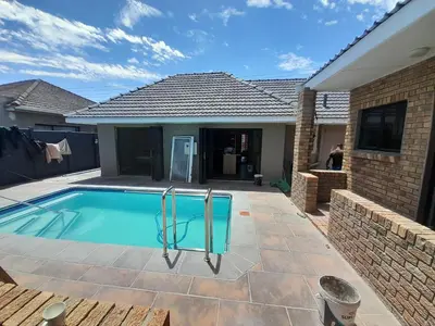 a swimming pool in the backyard of a house at Nana Guest House in Cape Town