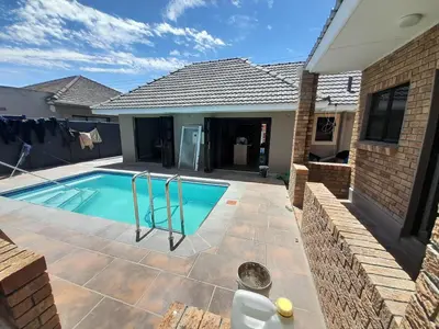 a swimming pool in the backyard of a house at Nana Guest House in Cape Town