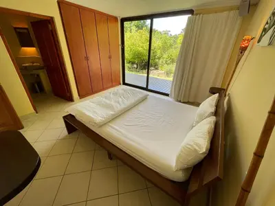 a small bed in a room with a window at Basco River Lodge Holiday Villa in Grabouw