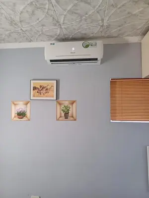 a wall with pictures and a projector on a white wall at Oakway Guest Suite in Cape Town