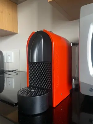 an orange and black object sitting on a counter at Studio in the City in Cape Town