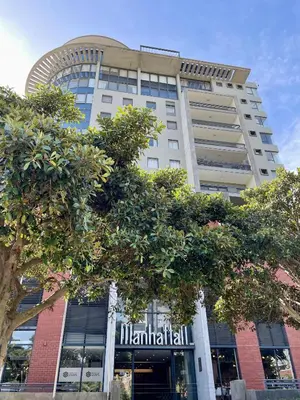 a tall building with trees in front of it at Studio in the City in Cape Town