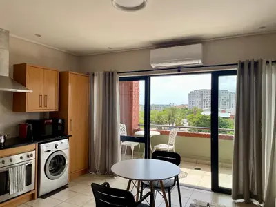 a kitchen with a table and a view of a city at Studio in the City in Cape Town