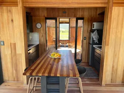 a kitchen with a wooden table with bananas on it at Natimby Lodge in Botrivier