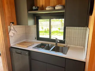 a kitchen with a sink and a window at Natimby Lodge in Botrivier