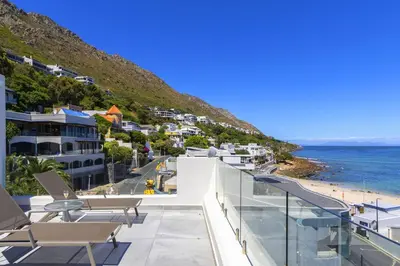 a view of the beach from the balcony of a villa at Bikini Beach Townhouse in Gordonʼs Bay