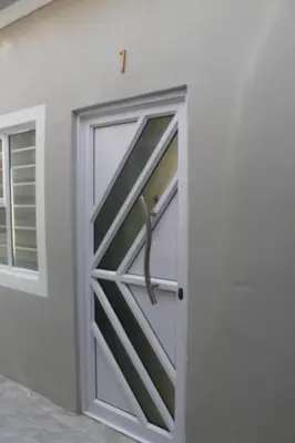 an open garage door with a window at one bedroom apartment A1 in Cape Town