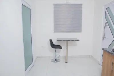 a desk and a chair in a white room at One Bedroom apartment A3 in Cape Town